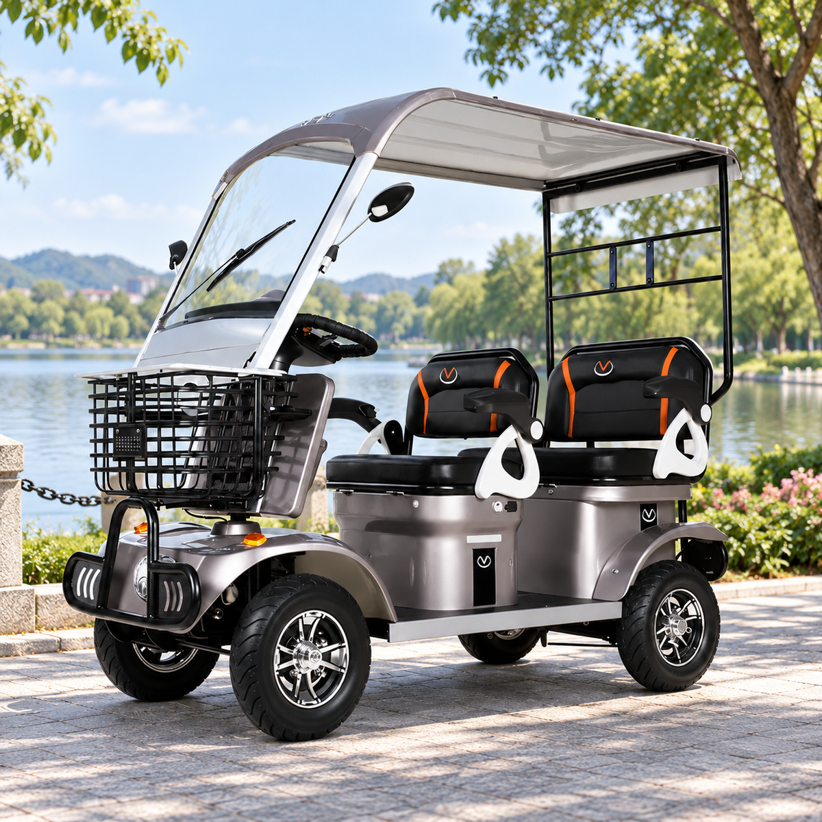 Coffee-coloured two-seat mobility scooter with canopy, windscreen, mirrors and front basket on a lakeside path