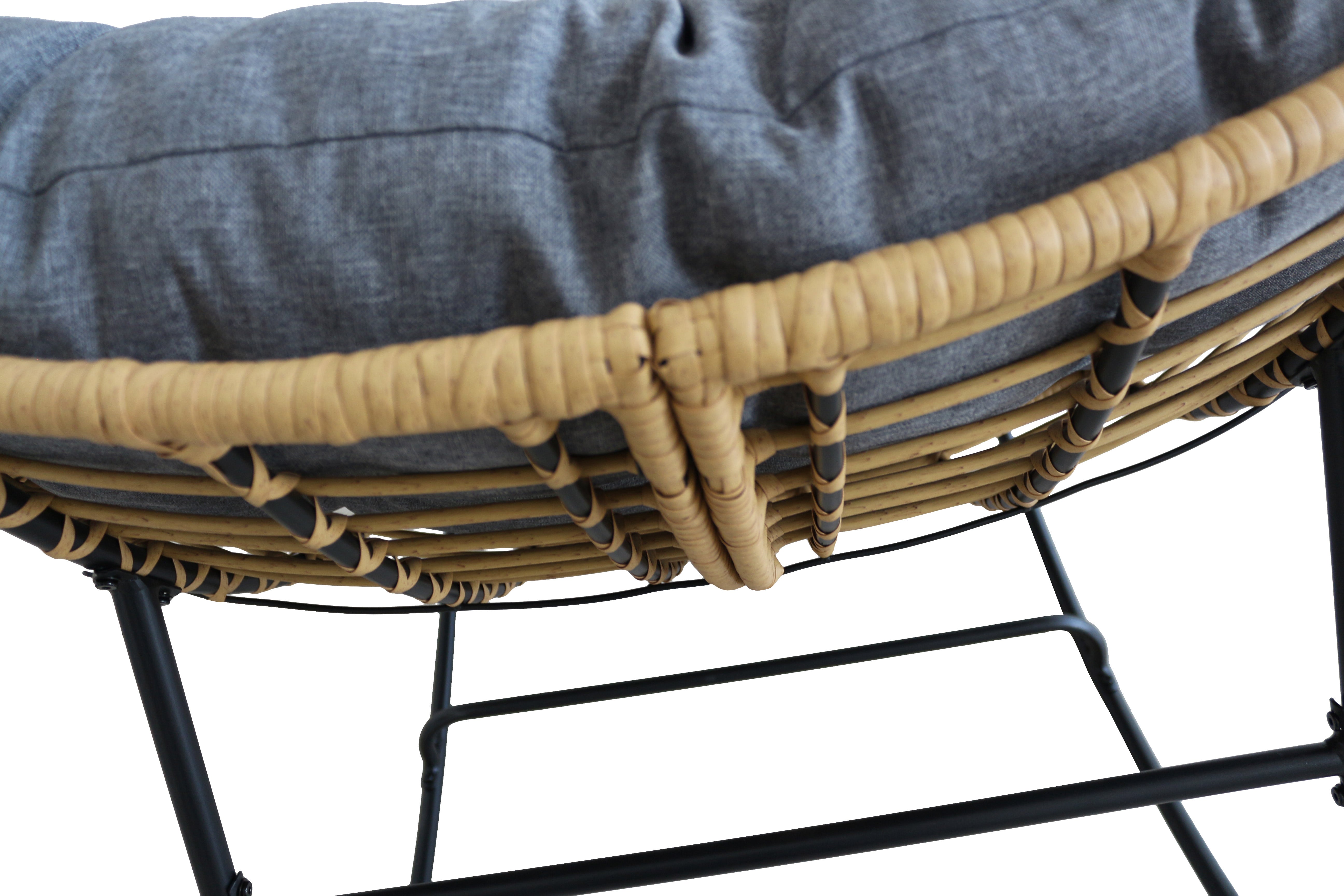 Close-up of a wicker chair with a cushion on a white background